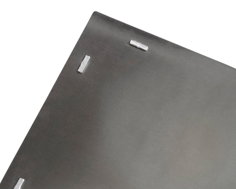 Frama Rivet Box Table in Aluminum, close up of a grey metal panel corner with the raised rivets that hold the sheets together
