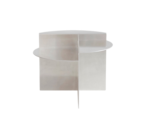 Frama Rivet Side Table in Aluminum, the table seen from behind, curved panel wrapping past the flat half round shelf