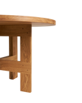 Frama Farmhouse Trestle Table in Natural Oak, close view of a trestle leg meeting the underside of the round top at a pegged joint