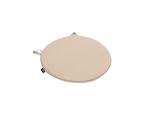 Frama Tasca Cushion in Beige, round seat pad with a fabric tie loop and a small woven label, shown at an angle on white