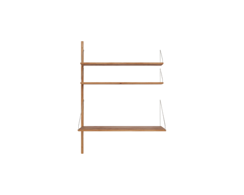 Frama Shelf Library Add-on Desk Section in Natural Oak, single upright with two narrow oak shelves above a deeper desk shelf, shown on white