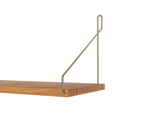 Frama Single Shelf, Natural Oak in Brass, close view of the shelf end with the brass bracket looped over the board edge