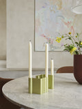 Muuto Pair Candleholder in green anodized aluminum with taper candles on marble dining table, Scandinavian modern interior