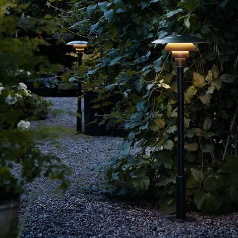 PH 3-2½ outdoor Bollard Lighting by louis poulsen in a garden