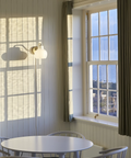 brass and opal glass wall lamp in a kitchen