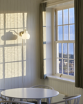 brass and opal glass wall lamp in a kitchen