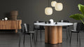 Blu Dot Buddy Chair in black on ash styled around the 4/4 Round Dining Table in a moody modern dining room