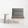 Perch Outdoor Lounge Chair by Blu Dot in Toohey Charcoal with white aluminum frame and teak slats, styled with Circula Tall Side Table in Putty