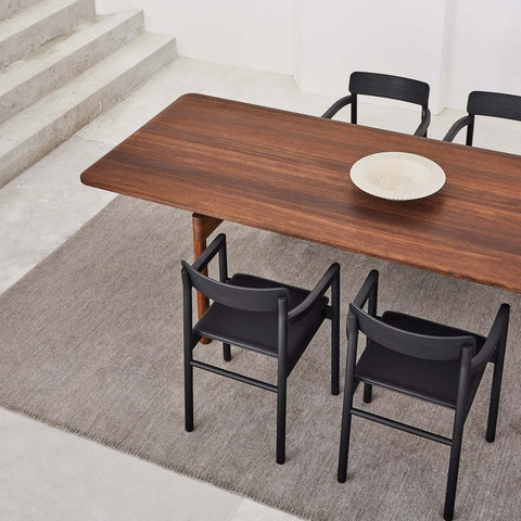 black dining chairs and smoked oak dining table designed by fredericia furniture