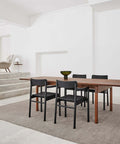 smoked oak dining table and black dining chairs designed by fredericia furniture