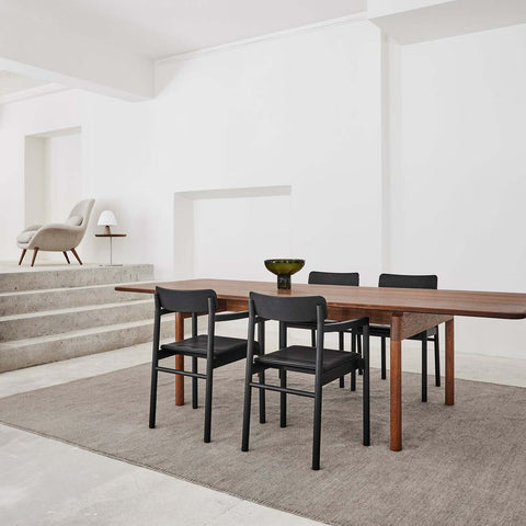 smoked oak dining table and black dining chairs designed by fredericia furniture