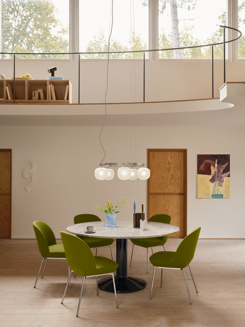 Muuto Rime Chandelier 5 in aluminium grey hanging above round marble dining table with green chairs in modern Scandinavian interior