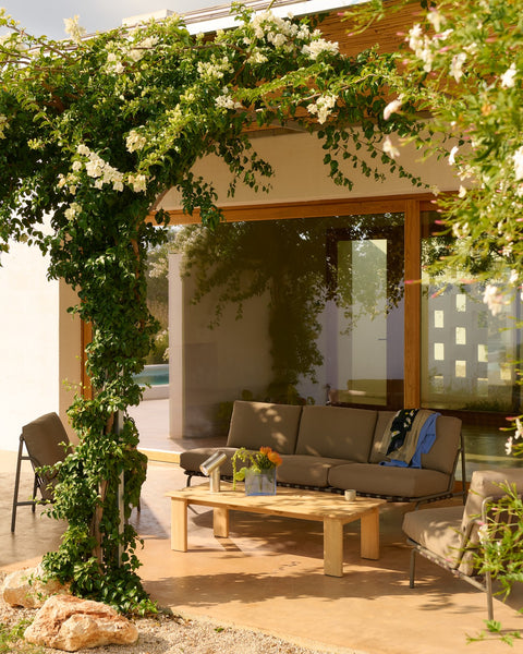 Muuto Settle 3 Seater Outdoor Sofa in Ribbed Weave 5 Taupe styled with Assemble Coffee Table 135 on sunlit patio