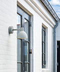 white outdoor wall lamp designed by louis poulsen