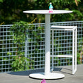 Skiff 30" Outdoor Bar Height Table by Blu Dot in white, styled on outdoor terrace with Skiff Outdoor Bar Stool