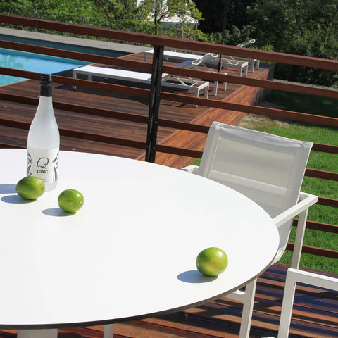 Skiff 47" Large Outdoor Café Table by Blu Dot, solid laminate tabletop detail styled on outdoor deck