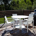 Skiff 47" Large Outdoor Café Table by Blu Dot in white, styled on outdoor deck with dining chairs