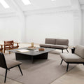 Scandinavian minimalist lounge area with marble coffee table and modern lounge chairs 