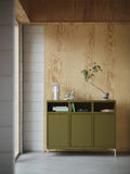 muuto stacked storage system in entryway lifestyle photo finished in brown green