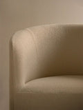 Audo Copenhagen Tearoom Chair, With Loose Cover, close-up of the Tearoom Lounge Chair's loose cover, showing the textured beige bouclé fabric on its curved back