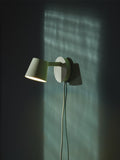 Muuto Tip Wall Lamp in modern living room setting with ambient lighting