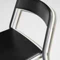 Trim Chair by Blu Dot in Black and Putty, stacked chairs showing perforated steel seat and back detail
