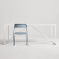 Trim Chair by Blu Dot in Grey Blue perforated powder-coated steel, front view with Strut dining table