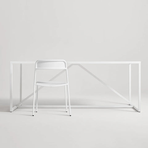 Trim Chair by Blu Dot in White perforated powder-coated steel, front view with Strut dining table