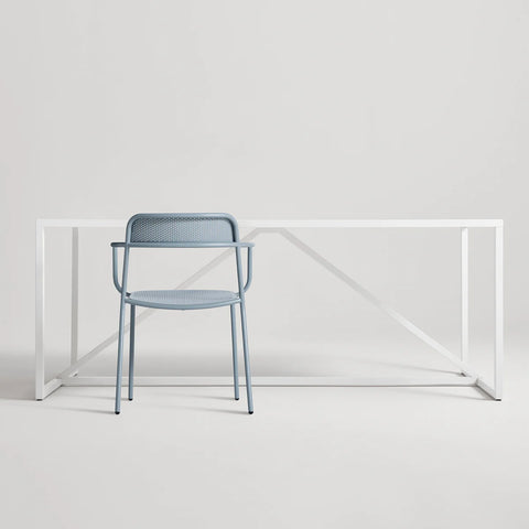 Trim Armchair by Blu Dot in Grey Blue perforated powder-coated steel, front view with Strut dining table