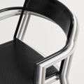 Trim Armchair by Blu Dot in Black and Putty, stacked chairs showing perforated steel seat and back detail