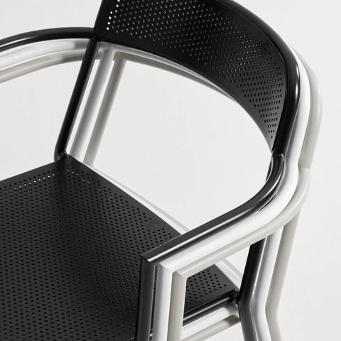 Trim Armchair by Blu Dot in Black and Putty, stacked chairs showing perforated steel seat and back detail