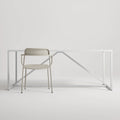 Trim Armchair by Blu Dot in Putty perforated powder-coated steel, front view with Strut dining table