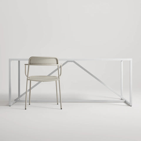 Trim Armchair by Blu Dot in Putty perforated powder-coated steel, front view with Strut dining table