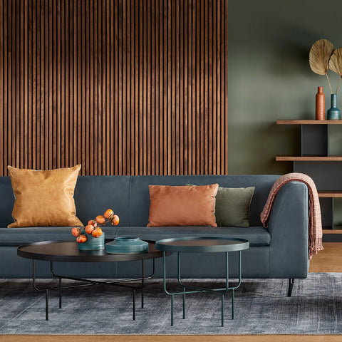 Blu Dot Bonnie 96" Sofa in slate blue fabric styled in a warm moody living room with wood slat wall