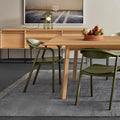 Blu Dot Dibs Chairs in loden stained beech wood, styled around a natural oak dining table in a modern dining room with oak sideboard, framed artwork, and grey rug