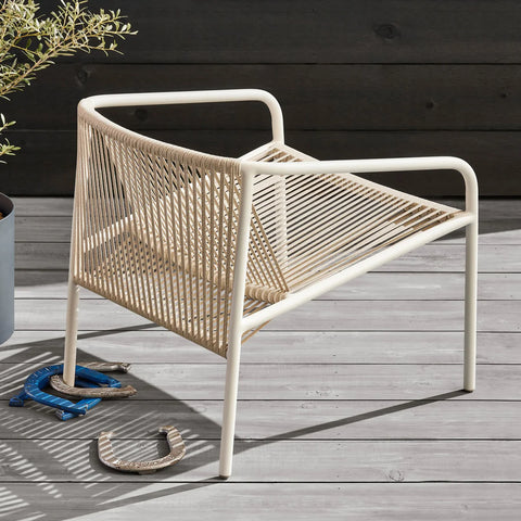 Lookout Outdoor Lounge Chair by Blu Dot in natural all-weather rope and white powder-coated aluminum, styled on outdoor deck