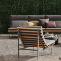 Perch Outdoor 3 Seat Sofa by Blu Dot in Toohey Charcoal with Charcoal frame, styled outdoors with Perch Lounge Chair and fire pit