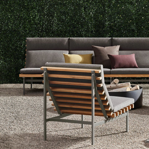 Perch Outdoor 3 Seat Sofa by Blu Dot in Toohey Charcoal with Charcoal frame, styled outdoors with Perch Lounge Chair and fire pit