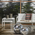 Wink Large Lantern by Blu Dot in Dark Olive, styled on outdoor side table with Wink Medium Lantern