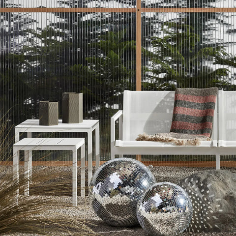 Wink Large Lantern by Blu Dot in Dark Olive, styled on outdoor side table with Wink Medium Lantern
