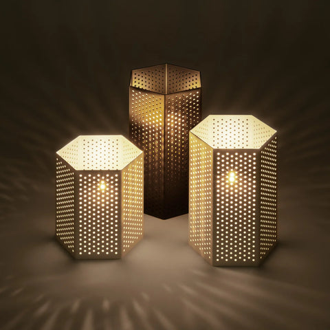 Wink Lanterns by Blu Dot in white and Dark Olive, small, medium, and large sizes lit with candles showing ambient glow