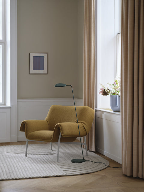 wrap lounge chair with a minimalist light fixture by muuto 